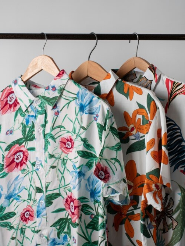 clothing-rack-with-hawaiian-shirts-with-floral-print-hangers-hat_23-2149366076